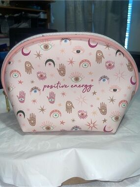 OCS DESIGNS Compact pink makeup pouch with a cheerful "positive energy" design.